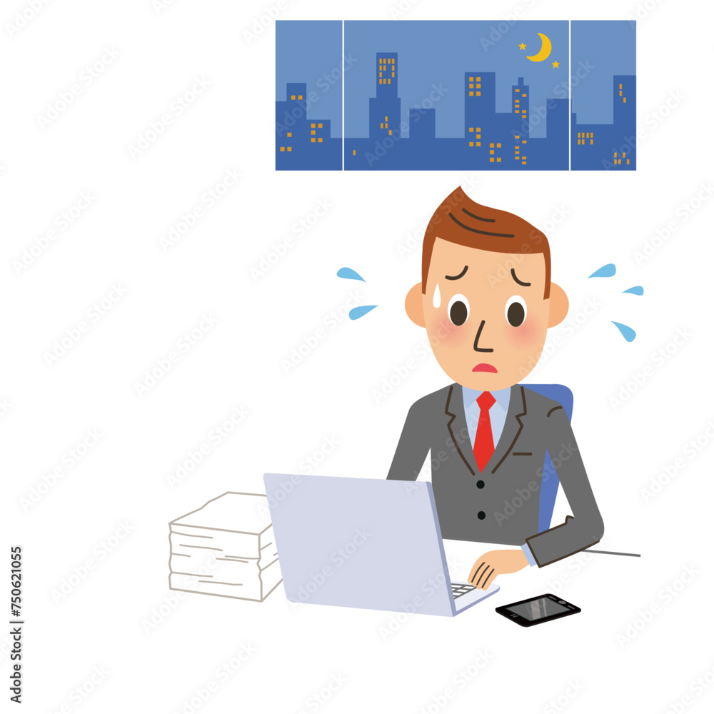 仕事が終わらないで残業をしている男性 仕事が終わらないで残業をしている男性