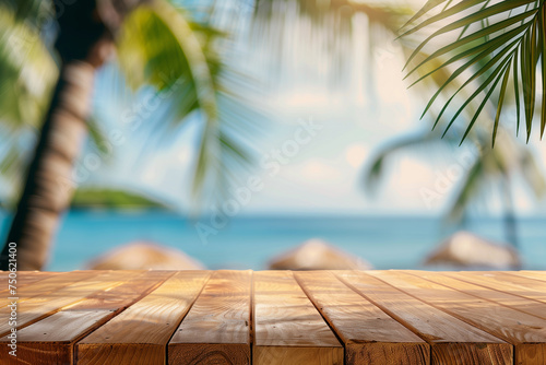 Top of wooden table with blurred bokeh light and palm leaf at tropical beach background. Free space