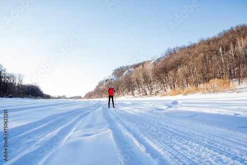 Winter skiing in the snow in the countryside, walk in the forest, mountain landscape, hilly terrain.