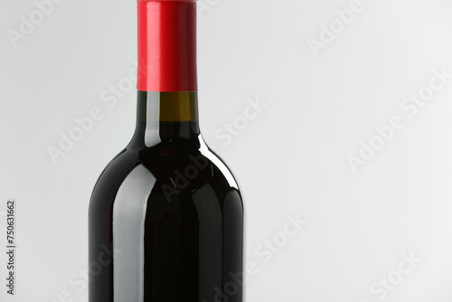 Bottle of expensive red wine on light background, closeup. Space for text