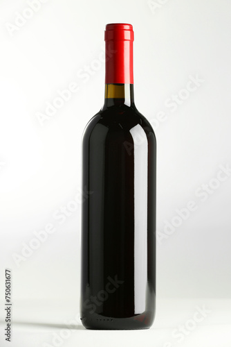 Bottle of expensive red wine on white background
