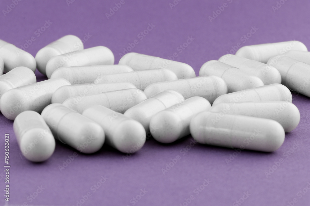 A stack of supplement capsules, dietary supplements, vitamin tablet, nutritional supplements in capsule form. A stack of supplement capsules, dietary supplements, vitamin tablet, nutritional supplements in capsule form.