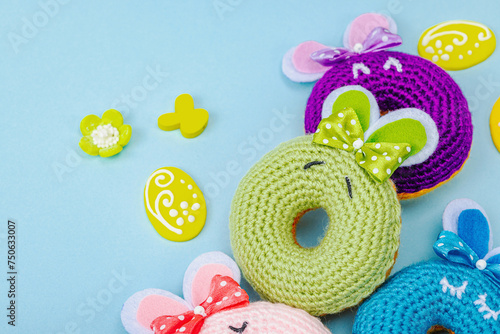 Handmade Easter concept. Crocheted donuts bunnies with traditional decoration. Festive symbols