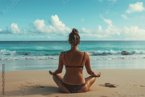 Back view full body portrait of a woman practicing yoga on the beach
