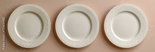 Closeup of white plate, Different size of plates on beige background