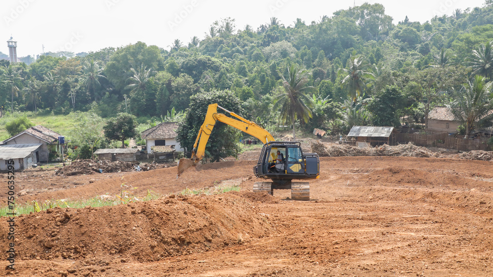 someone is operating heavy equipment in the field someone is operating heavy equipment in the field