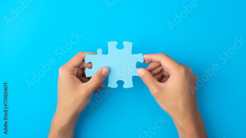 Hand Holding Puzzle Isolated on Blue Background