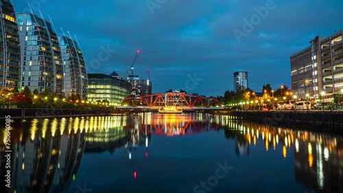 Time lapse Cityscape of Big Red Bridge and Media City UK waterfront around Salford Quays in Manchester at night, England, UK photo