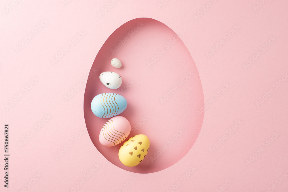 Celebratory Easter idea: top view of assorted eggs seen through an egg-shaped cutout on a delicate pink backdrop, with empty space for words