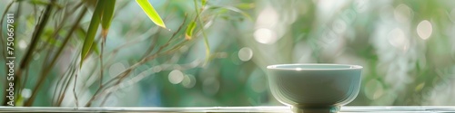 Serene Elegance, Celadon Porcelain Teacup Amidst a Bamboo Surrounding, Soft Colors Complemented by Dreamy Bokeh Background photo