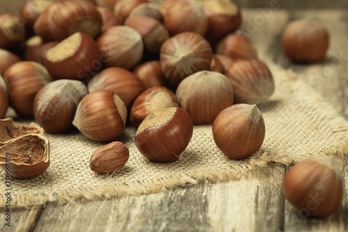Hazelnuts in the shell close-up. Hazelnut on a wooden table. Natural food products. Close up, copy space