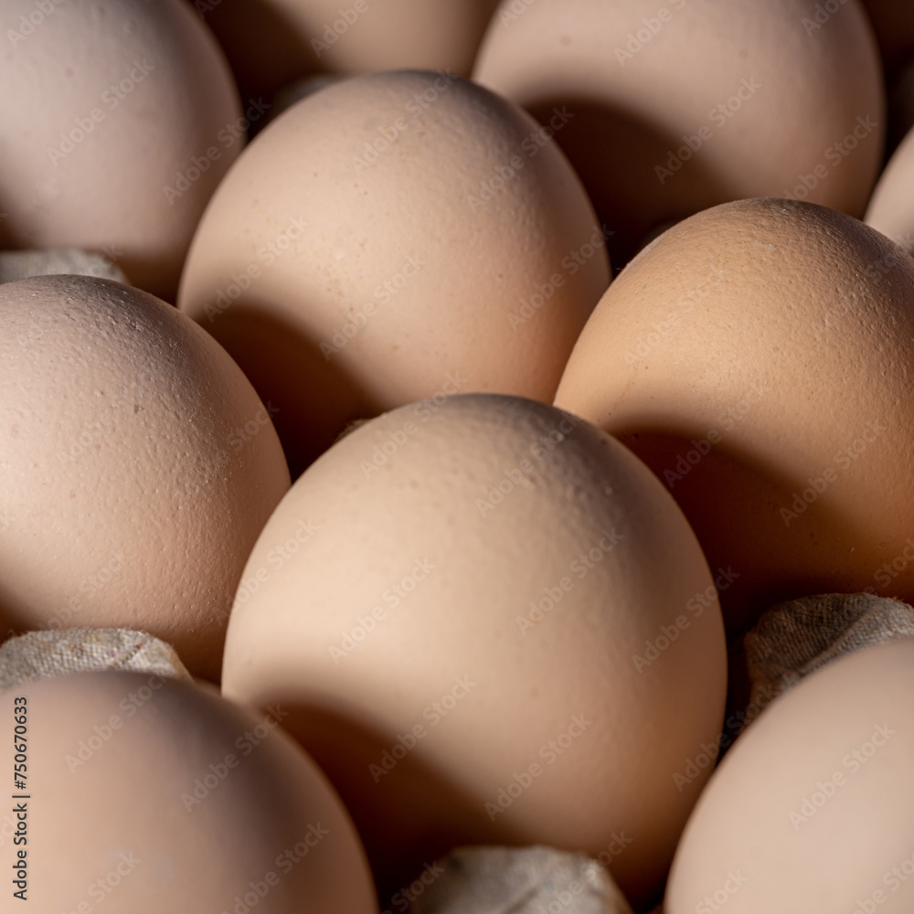 Brown eggs stacked in rows.Group of Fresh white Eggs in a cardboard cassette. Organic food from nature good for health. Brown eggs stacked in rows.Group of Fresh white Eggs in a cardboard cassette. Organic food from nature good for health.