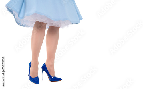 Perfect legs of female in blue skirt and blue high heels shoes isolated on white background