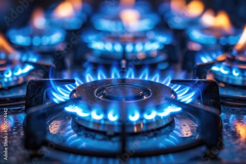 Gas burning from a kitchen gas stove. blue gas flame on hob. closeup selective focus natural 