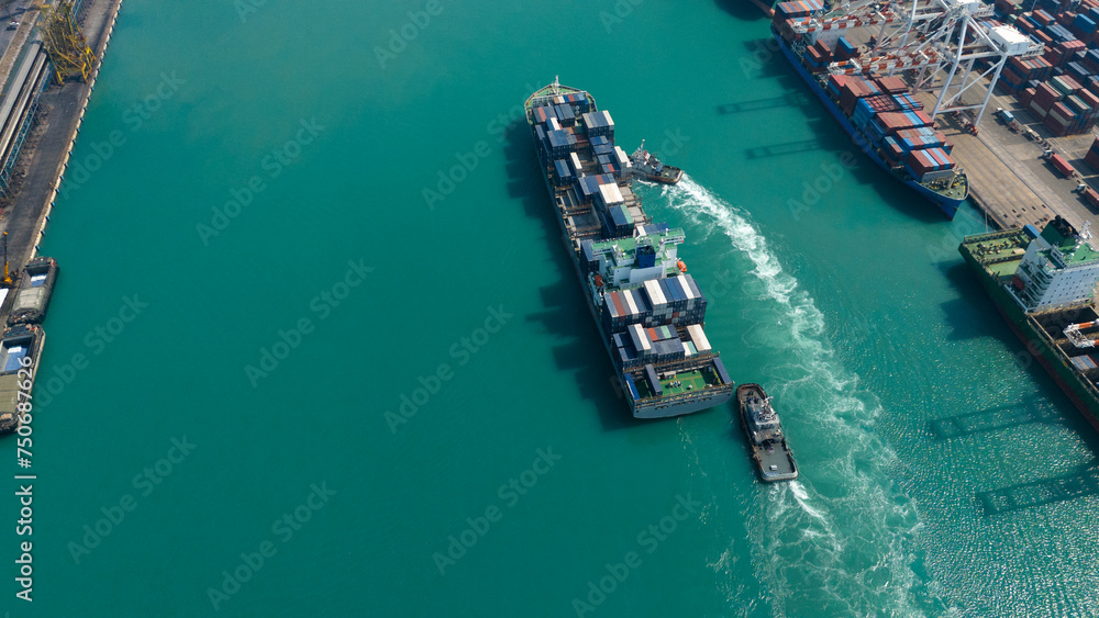 Aerial top view over international containers cargo ship at industrial import-export port prepare to load containers with big container loader ship vessel. global transportation and logistic business. Aerial top view over international containers cargo ship at industrial import-export port prepare to load containers with big container loader ship vessel. global transportation and logistic business.