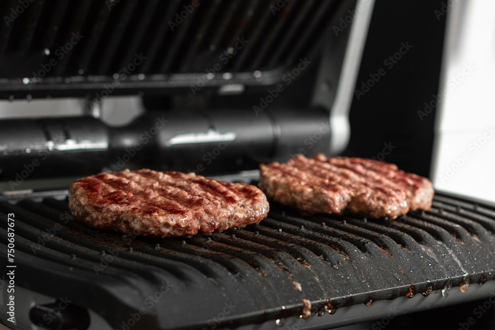 Juicy beef patty for burgers on a hot grill