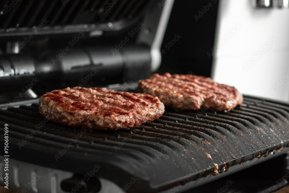 Freshly grilled burger meat. Burgers on the grill. Cooking burgers on hot grill Freshly grilled burger meat. Burgers on the grill. Cooking burgers on hot grill