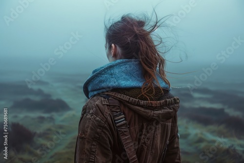 Young Woman Contemplating Nature in Misty Landscape, Tranquil Outdoor Adventure, Solitude and Travel Concept