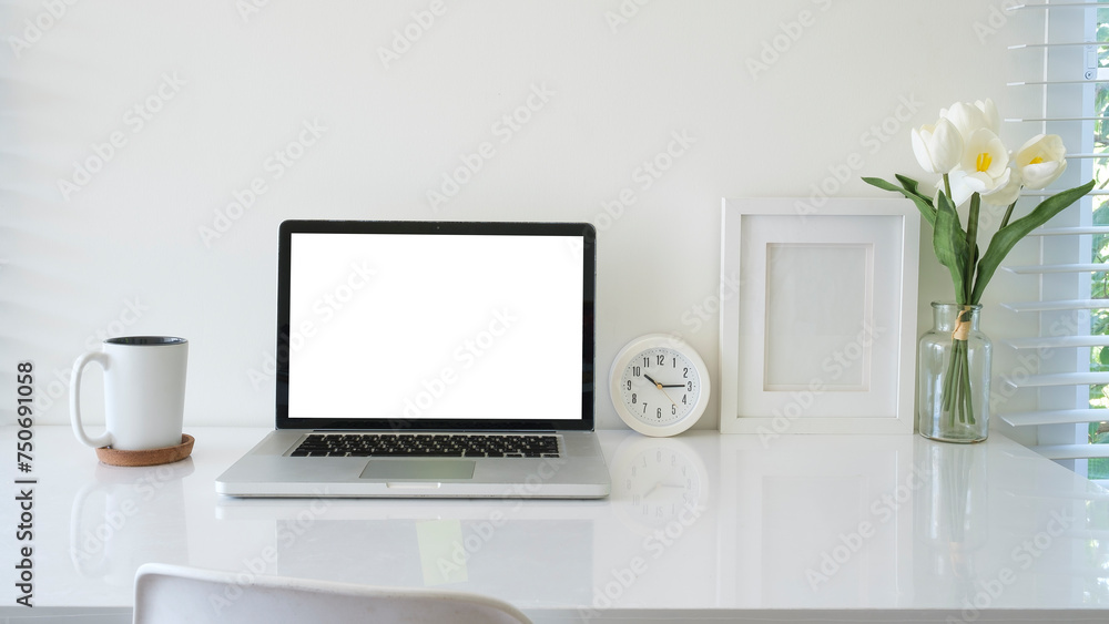 Fototapeta premium Computer laptop with empty screen, coffee cup, and potted plant on table. Home office.
