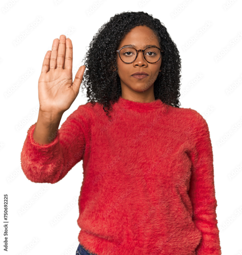 African American woman in studio setting standing with outstretched hand showing stop sign, preventing you. African American woman in studio setting standing with outstretched hand showing stop sign, preventing you.