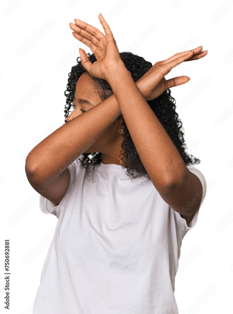 African American woman in studio setting keeping two arms crossed, denial concept.