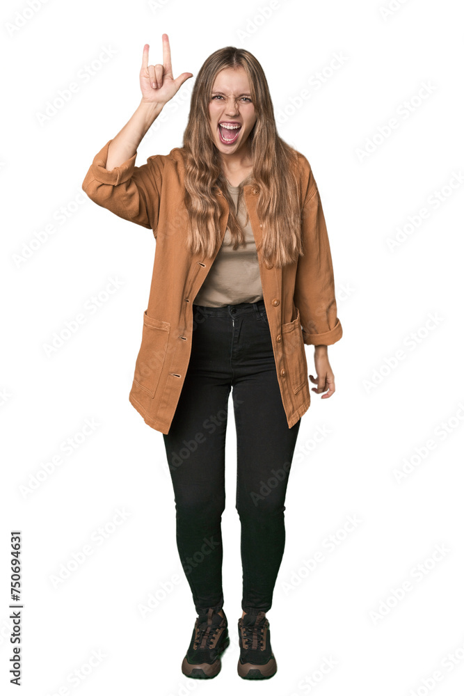 Studio portrait of a blonde Caucasian woman showing a horns gesture as a revolution concept. Studio portrait of a blonde Caucasian woman showing a horns gesture as a revolution concept.
