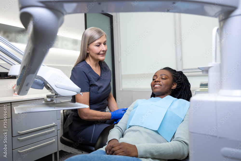 Multicultural lady in dental clinic doing teeth checkup Multicultural lady in dental clinic doing teeth checkup