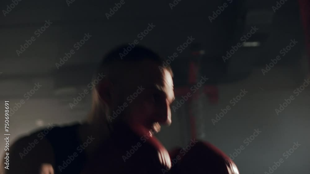 Sport motivation, portrait shot of athlete man boxing in the old school gym. Fit strong man training with boxing bag Sport motivation, portrait shot of athlete man boxing in the old school gym. Fit strong man training with boxing bag