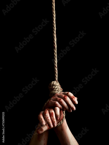 Woman hands with bloody stains tied with a rope over black background. Hostage