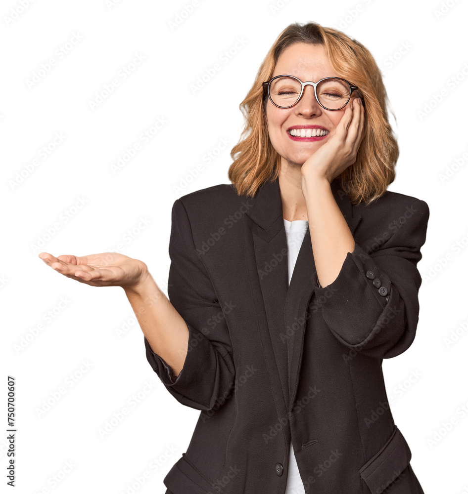 Caucasian woman in black business suit holds copy space on a palm, keep hand over cheek. Amazed and delighted. Caucasian woman in black business suit holds copy space on a palm, keep hand over cheek. Amazed and delighted.