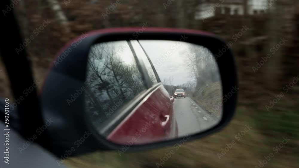 sees a car following in the rearview mirror sees a car following in the rearview mirror