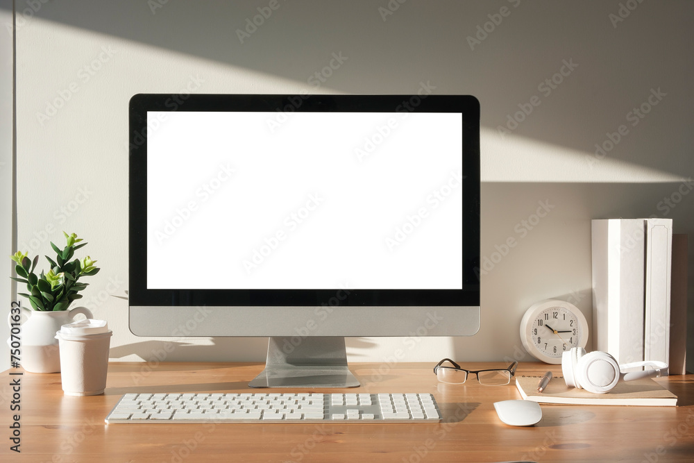 Front view blank computer desktop and office supplies on wooden table. Empty screen for advertising. Front view blank computer desktop and office supplies on wooden table. Empty screen for advertising.