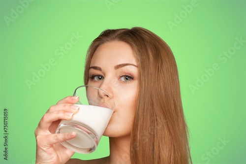 Young smiling woman hold glass of milk