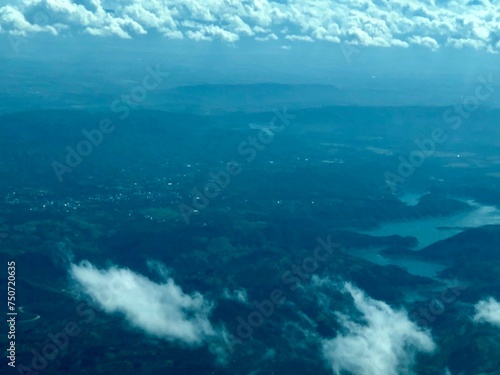 фотографія Aerial view of mountains and river from airplane. Cloudy day