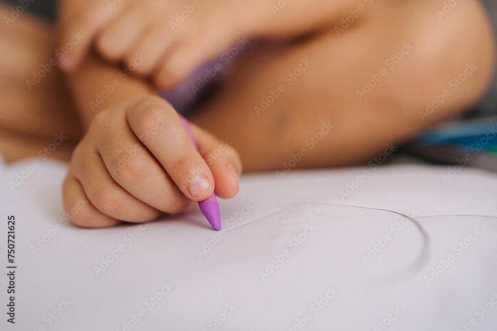 Close-up of little girl's hand with pencil. Five year old girl drawing at home after kindergarten. Magenta color Close-up of little girl's hand with pencil. Five year old girl drawing at home after kindergarten. Magenta color