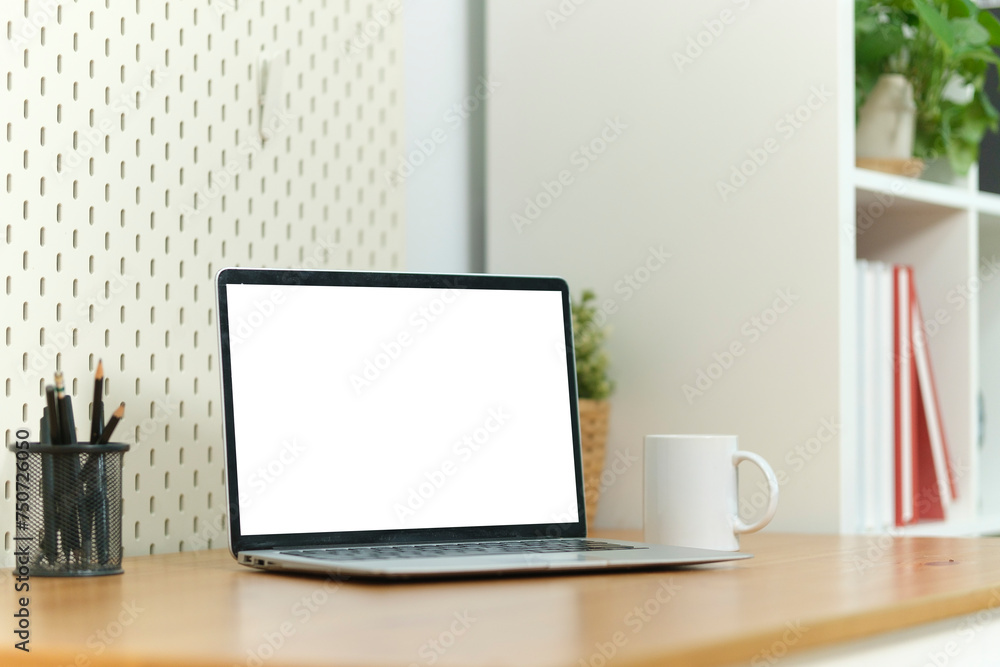 Fototapeta premium Home office desk with computer laptop, coffee cup and houseplant on wood table.