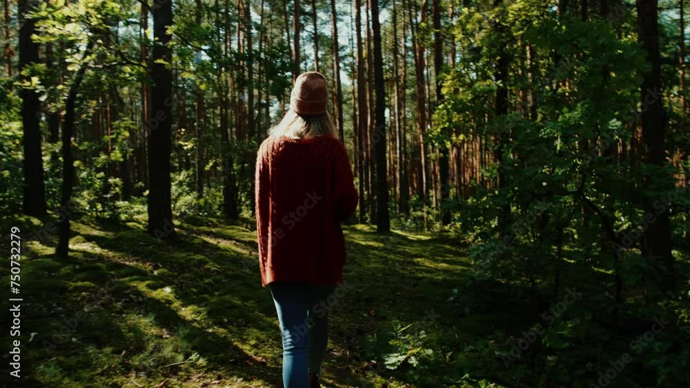 Beautiful young woman walking in the forest. Relaxing, meditating and finding a peace in the nature Beautiful young woman walking in the forest. Relaxing, meditating and finding a peace in the nature