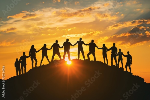 Silhouettes of professionals forming a human bridge, reaching towards a rising sun.