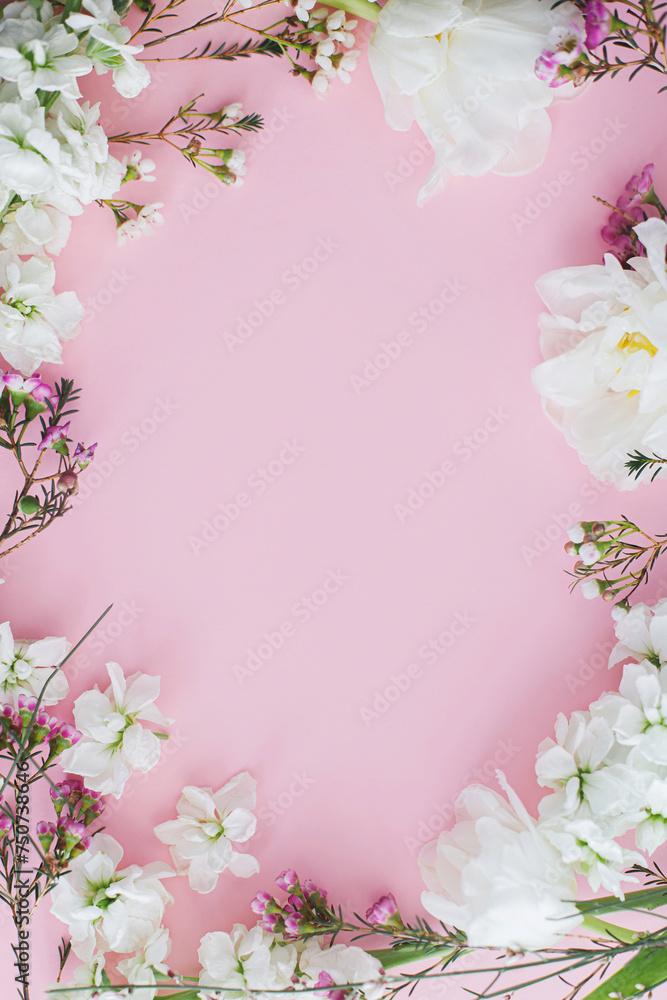 Stylish flowers flat lay on pink background with space for text. Happy womens day and Mothers day. Beautiful tulips and spring flowers frame, greeting card template. Floral banner Stylish flowers flat lay on pink background with space for text. Happy womens day and Mothers day. Beautiful tulips and spring flowers frame, greeting card template. Floral banner