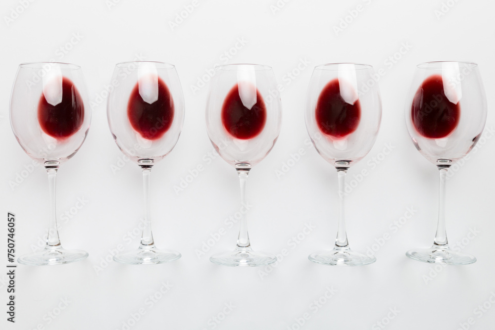 Many glasses of red wine at wine tasting. Concept of red wine on colored background. Top view, flat lay design Many glasses of red wine at wine tasting. Concept of red wine on colored background. Top view, flat lay design