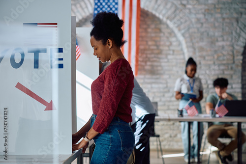 Black woman at voting booth during US elections. photo