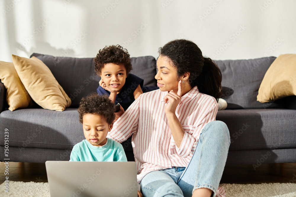 attractive jolly african american mother looking at her sons with love while watching movies attractive jolly african american mother looking at her sons with love while watching movies