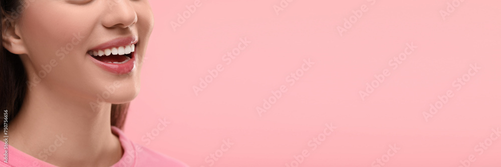 Woman with clean teeth smiling on pink background, closeup. Banner design with space for text Woman with clean teeth smiling on pink background, closeup. Banner design with space for text