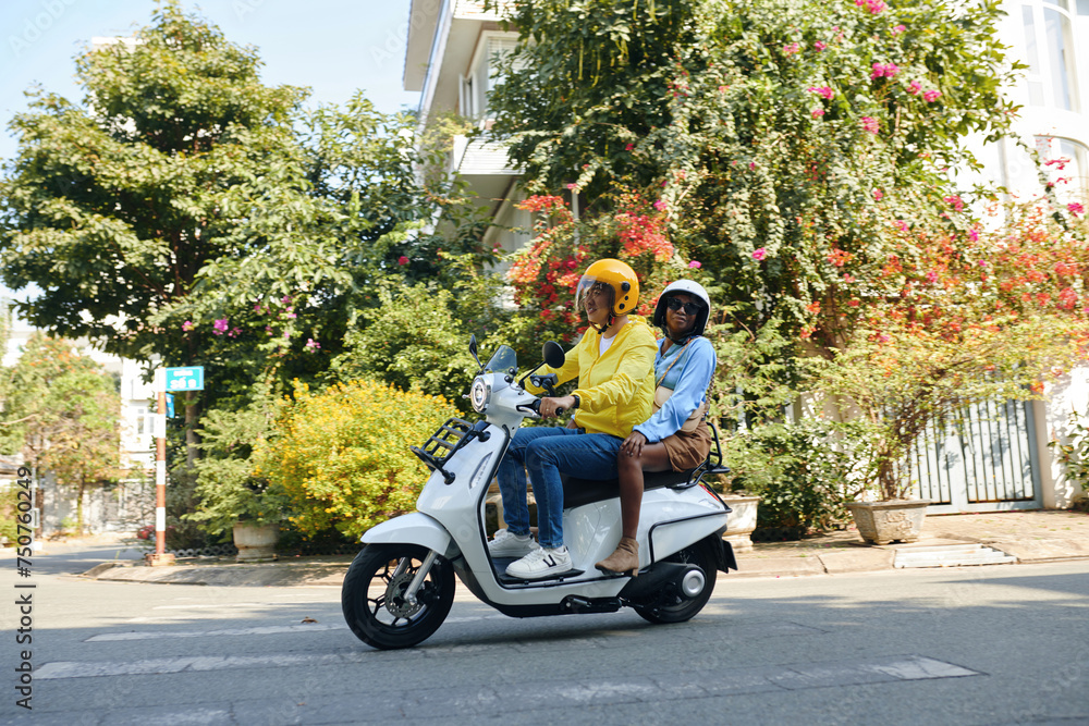 Woman riding motorbike taxi to get around town Woman riding motorbike taxi to get around town