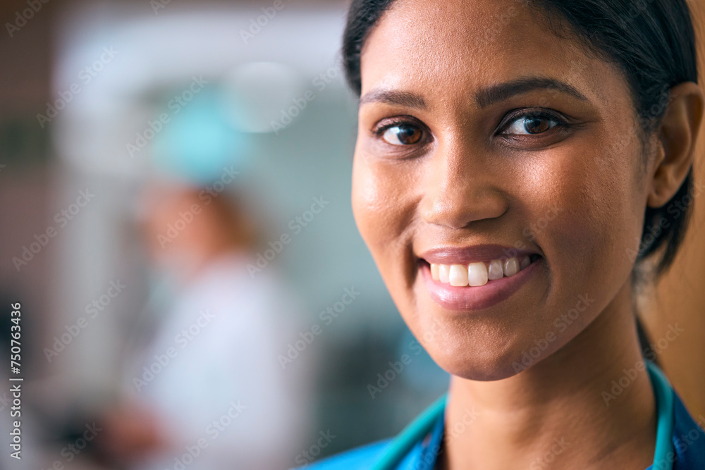 Close Up Portrait Of Smiling Female Doctor Or Nurse Wearing Scrubs And Stethoscope In Hospital Close Up Portrait Of Smiling Female Doctor Or Nurse Wearing Scrubs And Stethoscope In Hospital