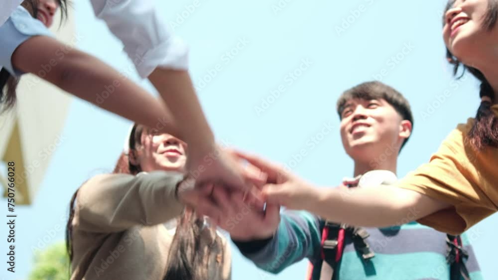 Young happy people put their hands together. Young happy people put their hands together.