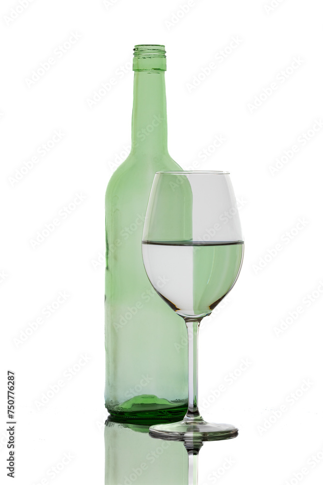 A colorful bottle with reflections in a wine glass
