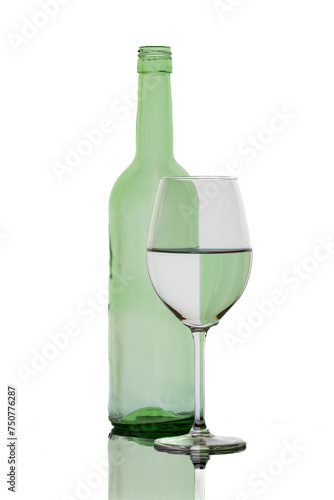 A colorful bottle with reflections in a wine glass 