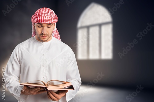 A man holding big holy Quran book in hands