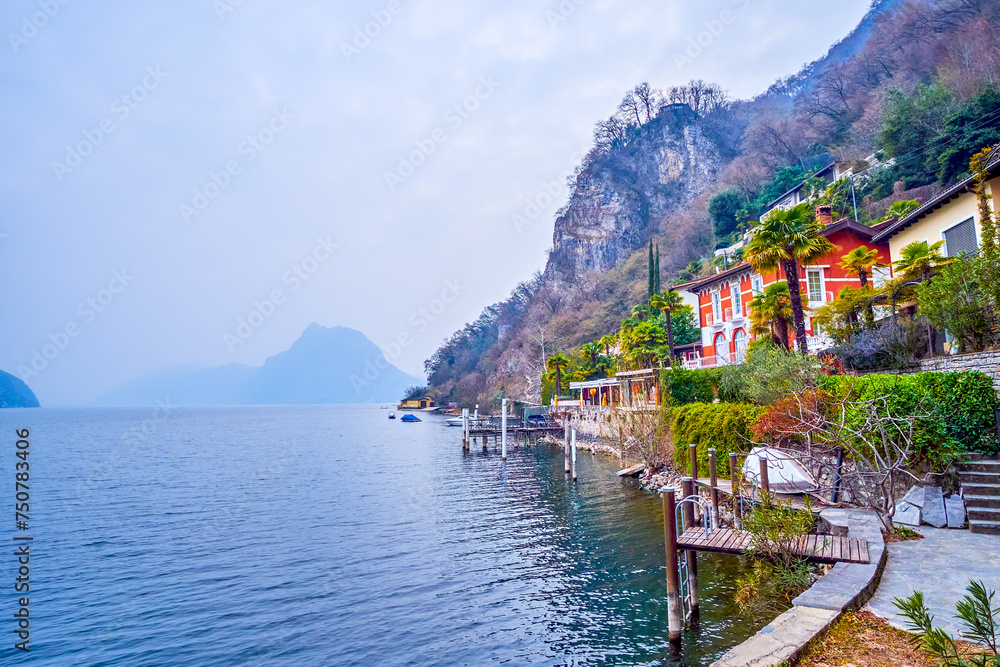Buildings on the rocky shore of Lake Lugano along Olive Tree Trail, Lugano, Switzerland